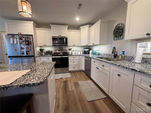 379 Lakeview Cpe, Girardeau, MO 63701 - kitchen with appliances with stainless steel finishes, a sink, wood finished floors, white cabinets, and recessed lighting