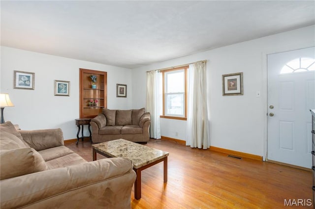 4 New Sugar Creek Rd, Fenton, MO 63026 - living area with healthy amount of natural light, baseboards, and light wood-style floors