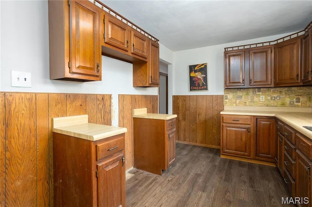 4 New Sugar Creek Rd, Fenton, MO 63026 - kitchen with a wainscoted wall, dark wood-style flooring, brown cabinets, light countertops, and wooden walls