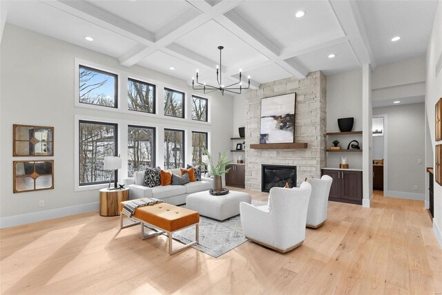 16908 Lewis Spring Farms Rd, Wildwood, MO 63005 - living area featuring light wood-style floors, a chandelier, baseboards, a stone fireplace, and coffered ceiling