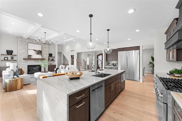 16908 Lewis Spring Farms Rd, Wildwood, MO 63005 - kitchen with stainless steel appliances, a sink, coffered ceiling, dark brown cabinets, and light wood-style floors