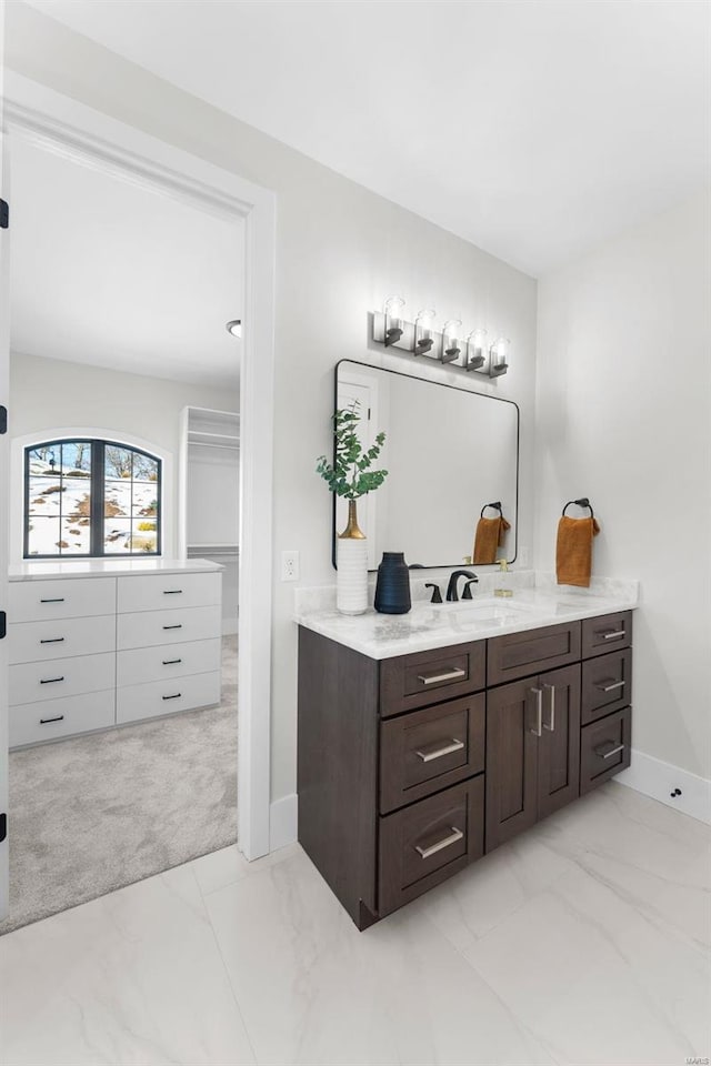 16908 Lewis Spring Farms Rd, Wildwood, MO 63005 - bathroom featuring marble look tile flooring, baseboards, and vanity