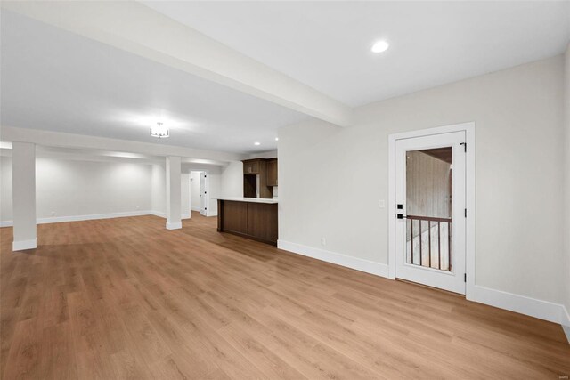 16908 Lewis Spring Farms Rd, Wildwood, MO 63005 - unfurnished living room with baseboards, light wood-type flooring, recessed lighting, and beamed ceiling