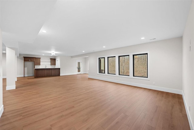16908 Lewis Spring Farms Rd, Wildwood, MO 63005 - unfurnished living room with baseboards, light wood-style floors, and recessed lighting