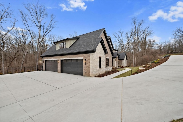 16908 Lewis Spring Farms Rd, Wildwood, MO 63005 - view of side of home featuring stone siding, concrete driveway, fence, roof with shingles, and a garage