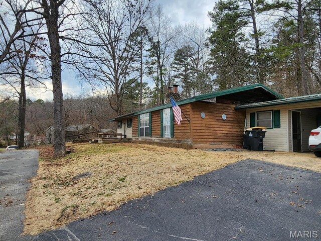 1504 Main St, Van Buren, MO 63965 - view of home's exterior with a chimney and asphalt driveway