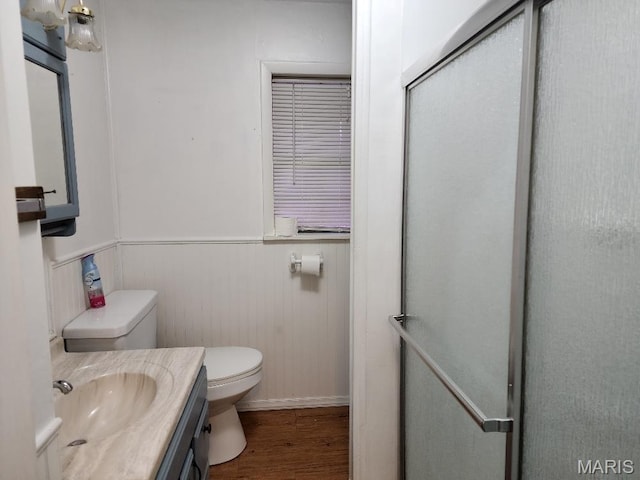 1504 Main St, Van Buren, MO 63965 - full bathroom featuring wood finished floors, toilet, a stall shower, vanity, and wainscoting