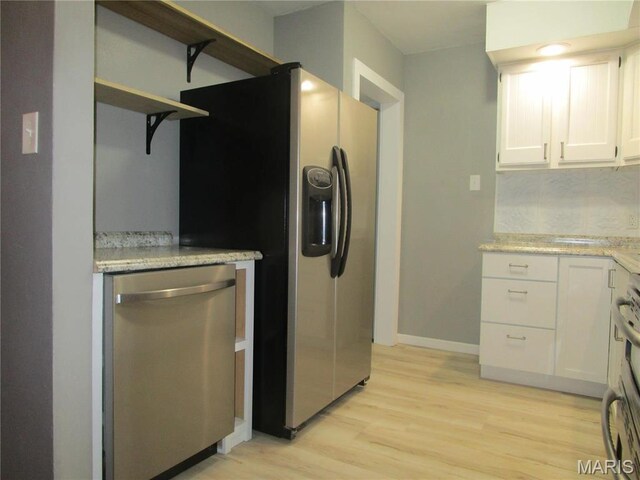 7 Pineview Ln, Collinsville, IL 62234 - kitchen with appliances with stainless steel finishes, open shelves, light wood-style flooring, baseboards, and white cabinets