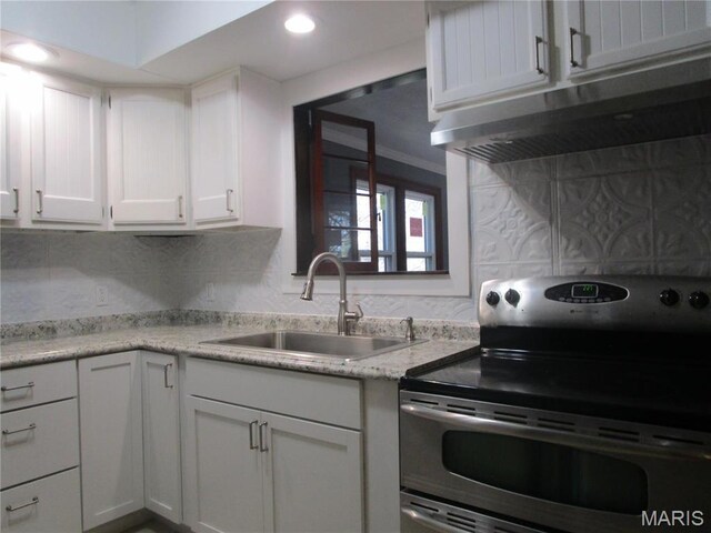 7 Pineview Ln, Collinsville, IL 62234 - kitchen featuring stainless steel range with electric stovetop, a sink, white cabinets, decorative backsplash, and recessed lighting