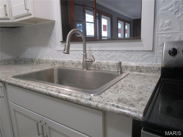 7 Pineview Ln, Collinsville, IL 62234 - kitchen view of a sink, light countertops, white cabinetry, ornamental molding, and stainless steel electric range