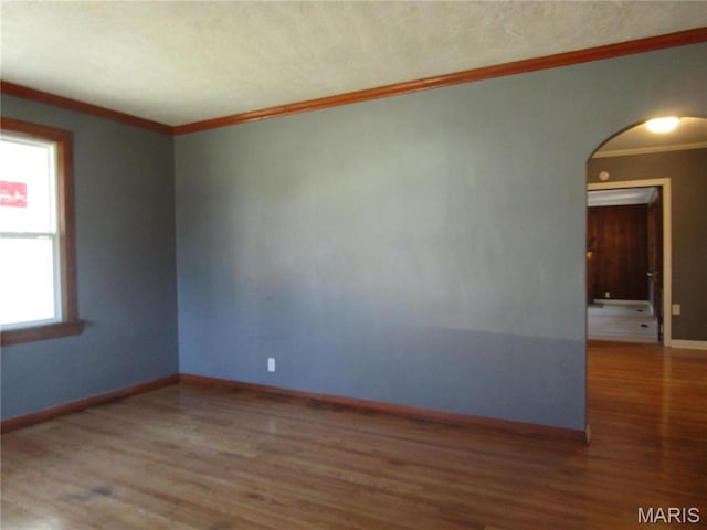 7 Pineview Ln, Collinsville, IL 62234 - unfurnished room featuring arched walkways, wood finished floors, ornamental molding, and baseboards
