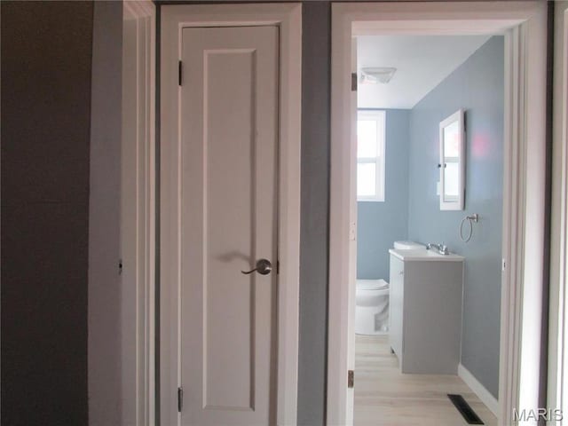 7 Pineview Ln, Collinsville, IL 62234 - bathroom featuring toilet, vanity, baseboards, and wood finished floors