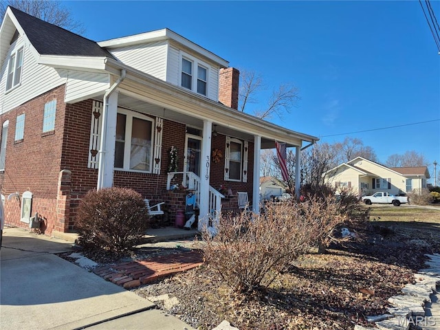 3019 Mockingbird Ln, Granite City, IL 62040 - view of front of property with brick siding, covered porch, and a chimney