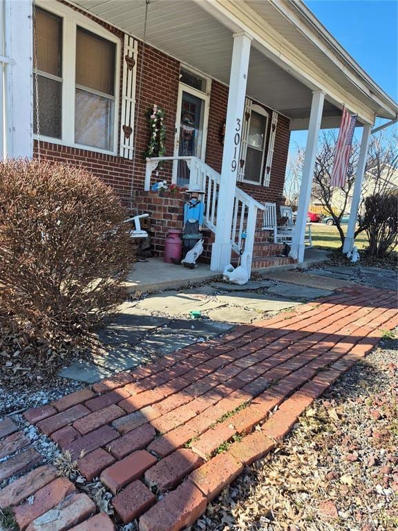 3019 Mockingbird Ln, Granite City, IL 62040 - doorway to property with brick siding and covered porch