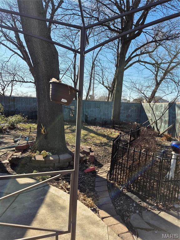 3019 Mockingbird Ln, Granite City, IL 62040 - fenced backyard with a patio area