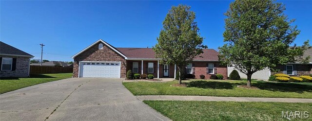 single story home featuring a garage, driveway, and a front yard