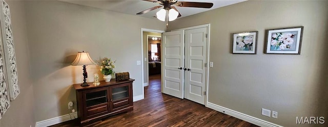 hall featuring baseboards and dark wood-style floors