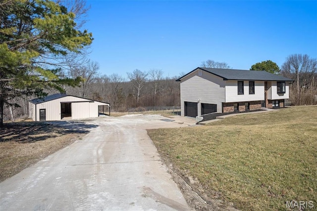 719 Green Ridge Dr, Catawissa, MO 63015 - view of side of property featuring driveway, a yard, an attached garage, an outdoor structure, and a pole building