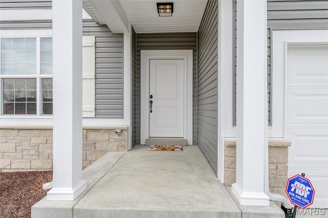 view of exterior entry with covered porch