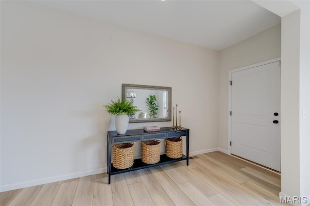 entryway with wood finished floors and baseboards