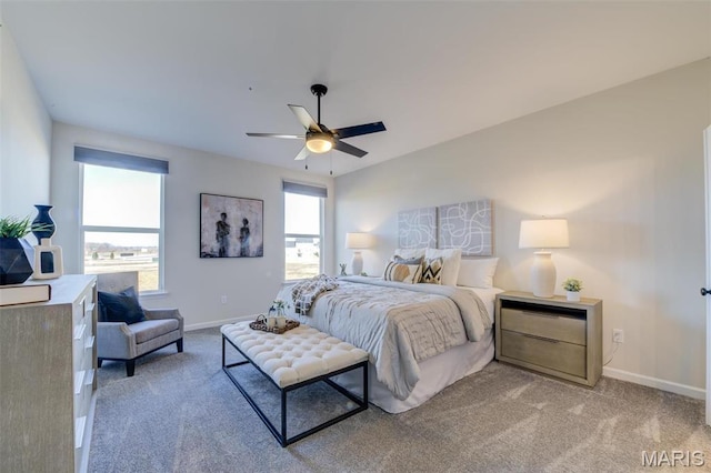 bedroom featuring baseboards, light carpet, and a ceiling fan