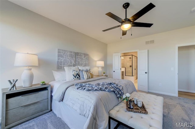 bedroom with carpet floors, baseboards, a ceiling fan, and ensuite bathroom