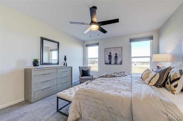 bedroom featuring baseboards, light carpet, and a ceiling fan