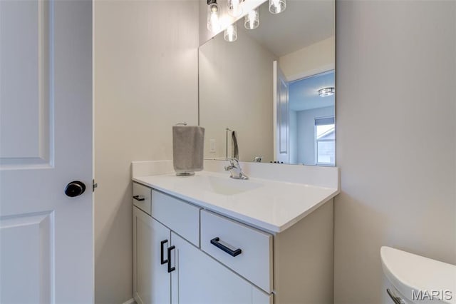 bathroom with vanity and toilet
