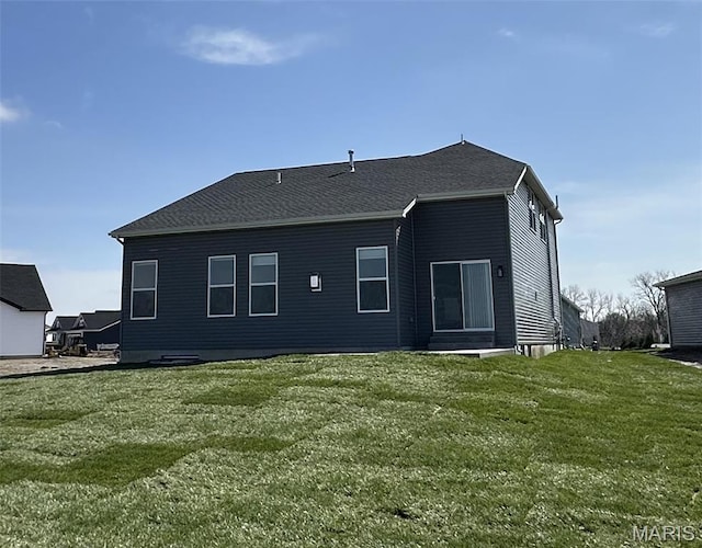 back of property featuring a lawn
