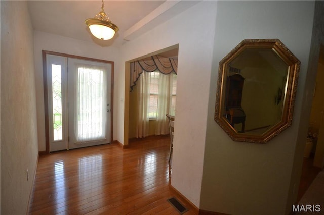 entryway featuring hardwood / wood-style floors and baseboards