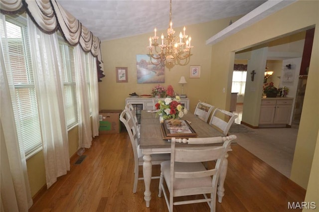 dining area featuring a chandelier and light wood-style flooring
