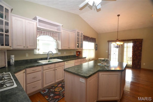 kitchen featuring a sink, ceiling fan, vaulted ceiling, gas stovetop, and dark countertops