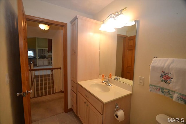 bathroom featuring vanity, tile patterned floors, and toilet