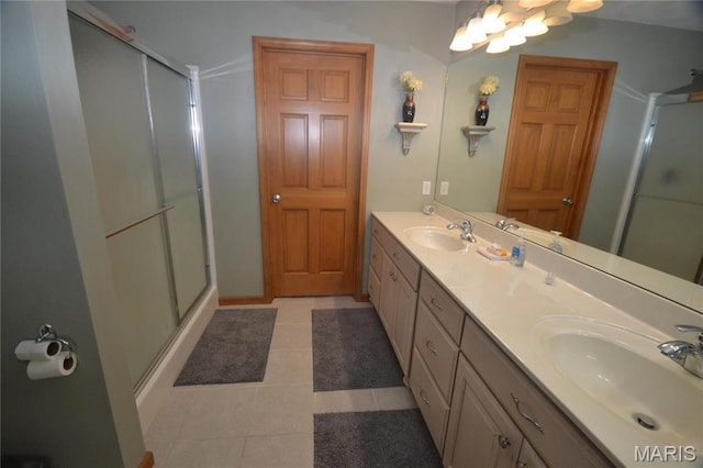 bathroom featuring a shower stall, double vanity, tile patterned floors, and a chandelier