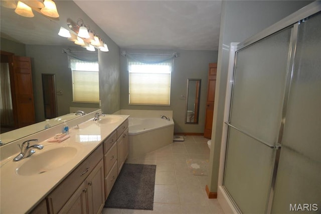 bathroom featuring healthy amount of natural light, a garden tub, and a stall shower