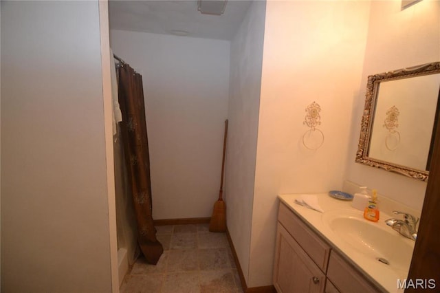full bathroom with vanity, a shower with curtain, and baseboards