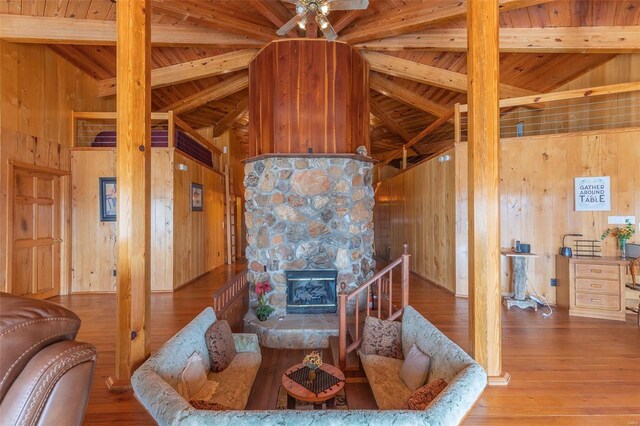 64 Trails End Ln, Doniphan, MO 63935 - living room featuring wooden walls, beam ceiling, hardwood / wood-style flooring, wood ceiling, and a fireplace