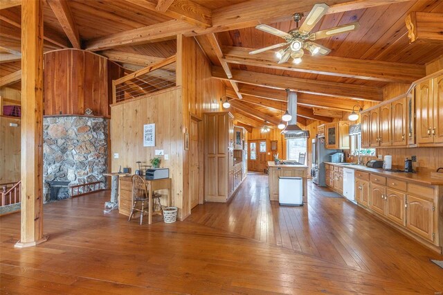 64 Trails End Ln, Doniphan, MO 63935 - kitchen with wood-type flooring, wooden walls, dishwasher, a center island, and freestanding refrigerator