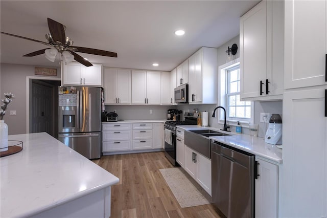 14822 Cedar Cove Pl, New London, MO 63459 - kitchen featuring stainless steel appliances, ceiling fan, a sink, white cabinets, and recessed lighting