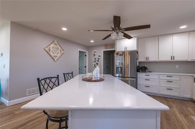 14822 Cedar Cove Pl, New London, MO 63459 - kitchen featuring stainless steel fridge with ice dispenser, ceiling fan, white cabinetry, light wood finished floors, and recessed lighting