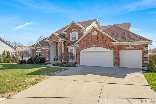 406 Clayton Hollow Dr, Wildwood, MO 63005 - traditional-style house with brick siding, a front yard, an attached garage, roof with shingles, and driveway