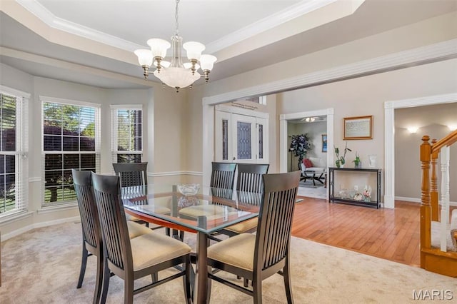406 Clayton Hollow Dr, Wildwood, MO 63005 - dining room featuring a chandelier, light colored carpet, baseboards, crown molding, and light wood-type flooring