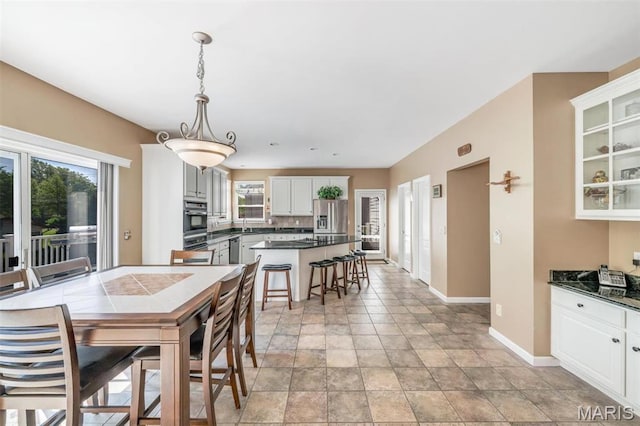 406 Clayton Hollow Dr, Wildwood, MO 63005 - dining space with baseboards and light stone finish floors