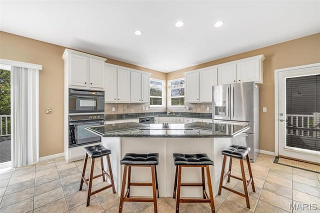 406 Clayton Hollow Dr, Wildwood, MO 63005 - kitchen featuring stainless steel fridge, a kitchen breakfast bar, white cabinets, baseboards, and decorative backsplash