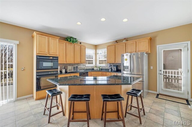 406 Clayton Hollow Dr, Wildwood, MO 63005 - kitchen with black appliances, light brown cabinets, baseboards, a kitchen breakfast bar, and recessed lighting