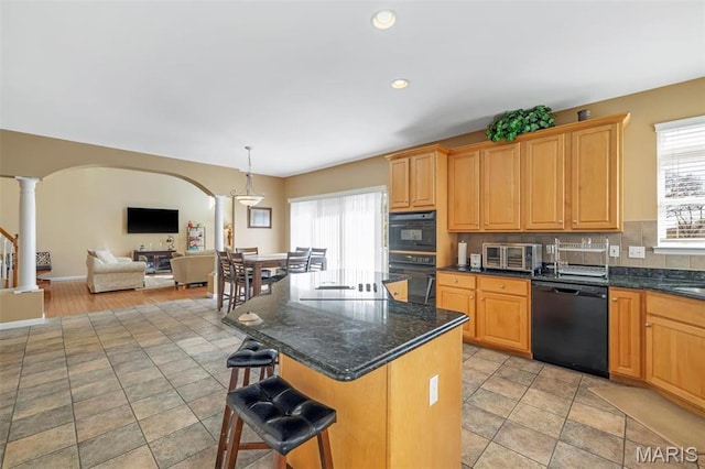 406 Clayton Hollow Dr, Wildwood, MO 63005 - kitchen featuring black appliances, ornate columns, plenty of natural light, arched walkways, and recessed lighting