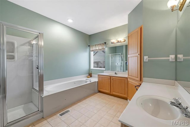 406 Clayton Hollow Dr, Wildwood, MO 63005 - full bath featuring a stall shower, two vanities, a garden tub, and tile patterned floors
