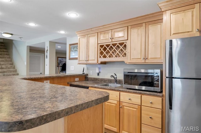 406 Clayton Hollow Dr, Wildwood, MO 63005 - kitchen featuring appliances with stainless steel finishes, a sink, light brown cabinets, dark countertops, and recessed lighting