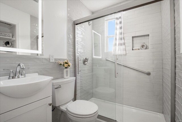 2330 Chambers Rd, Saint Louis, MO 63136 - full bath with toilet, a shower stall, tile walls, and vanity