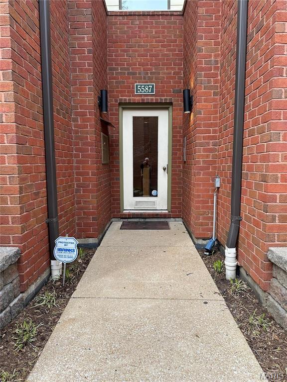 entrance to property with brick siding